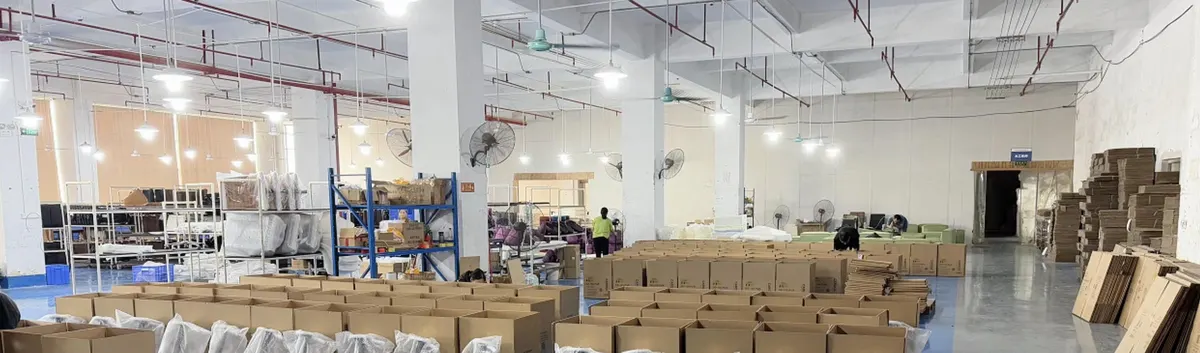 Open cardboard cartons and plastic-wrapped items laid out across a warehouse floor